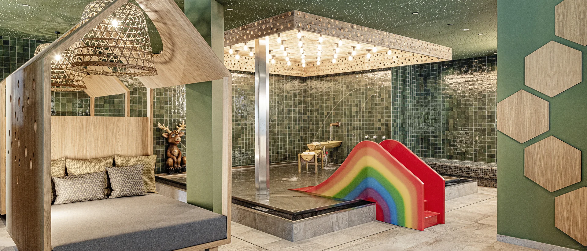 Family wellness hotel in South Tyrol with 60 metre water slide Family in the family pool at Hotel Schwarzenstein with 60 metre water slide for family holidays in South Tyrol